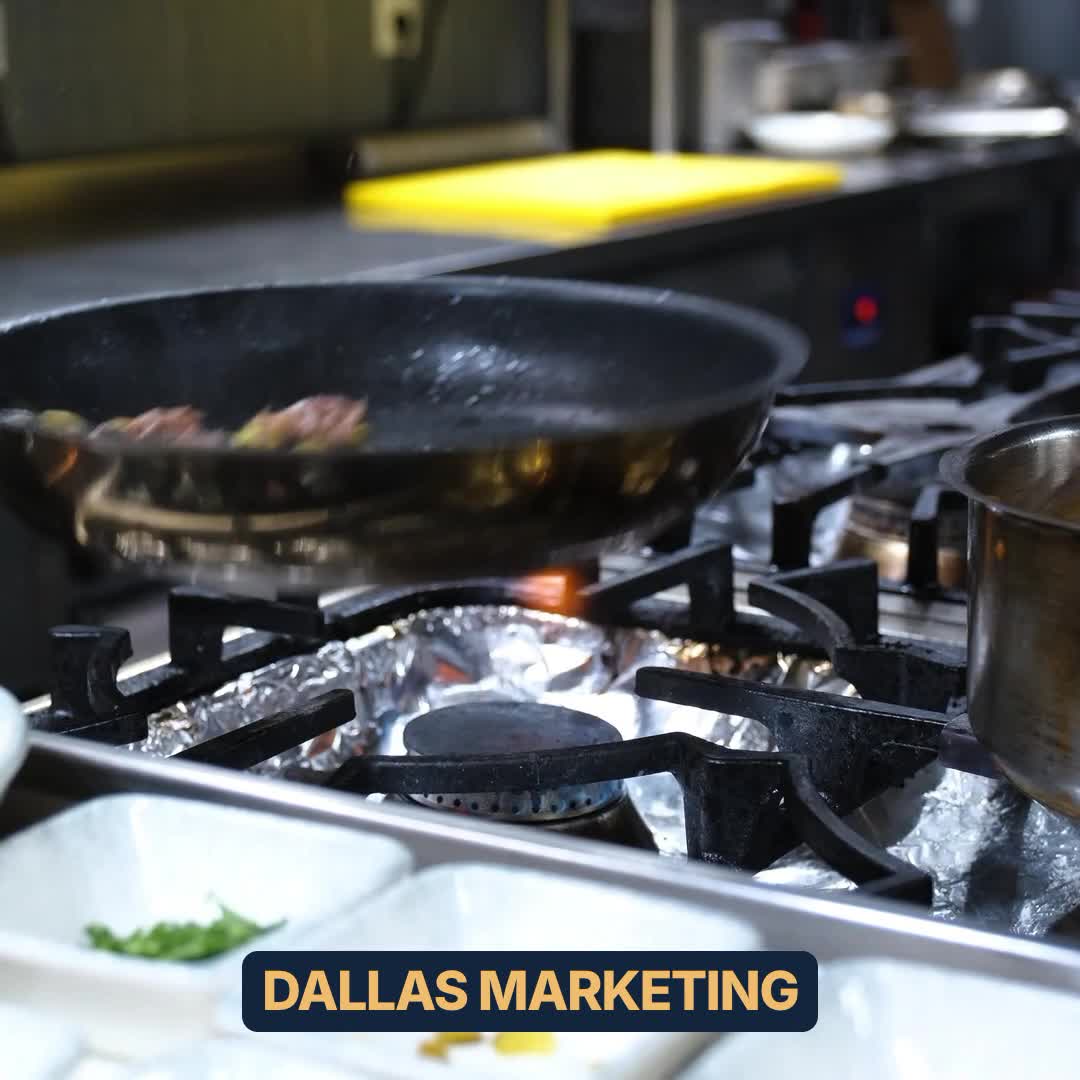 A chef moves a pan over a gas flame. Illustrative stock footage, not a client.