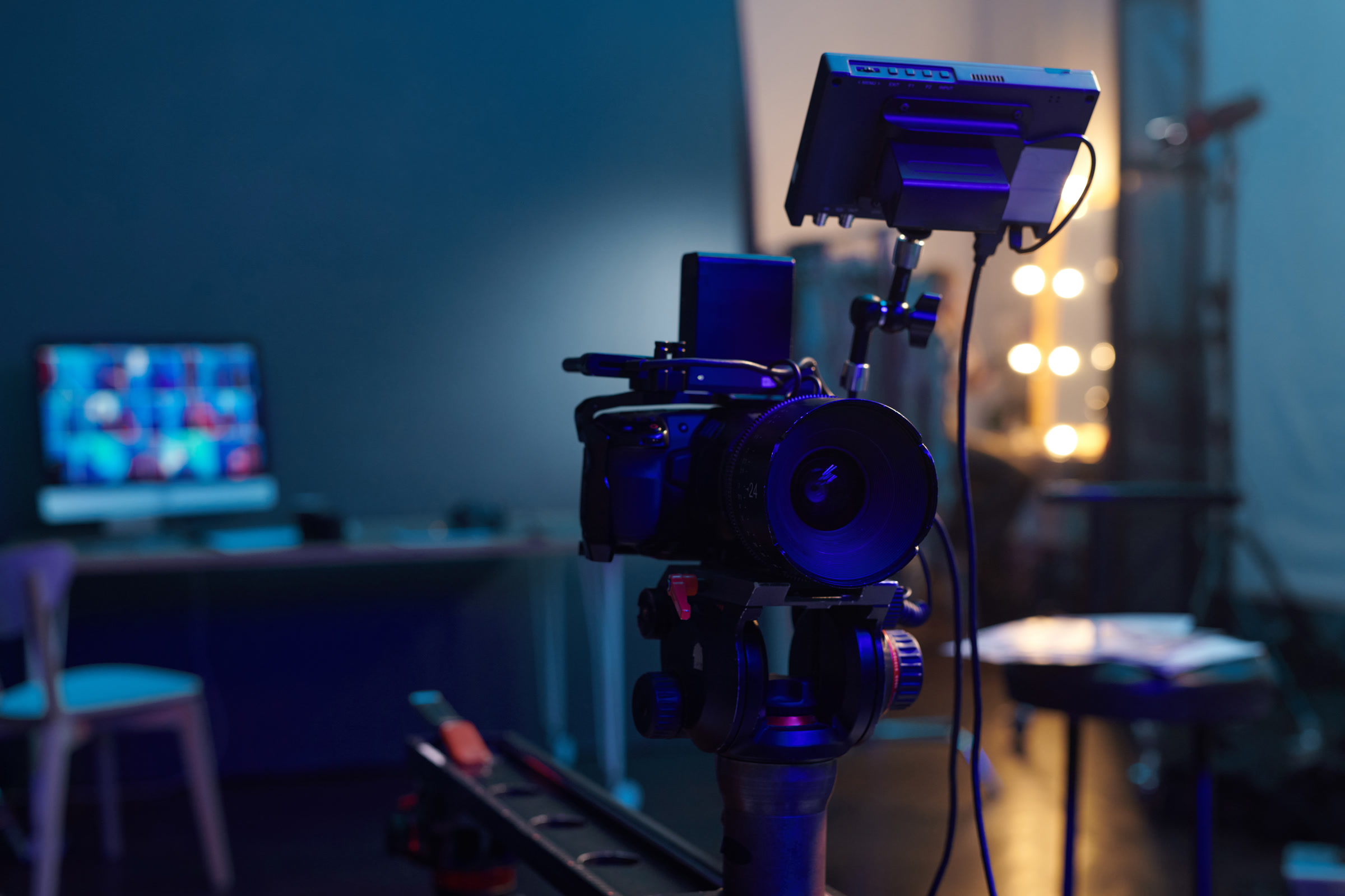 Cinema camera on a stand in a lit studio
