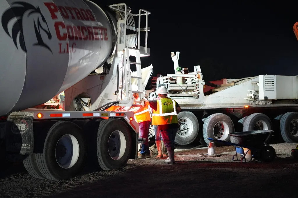 Potros Concrete LLC: crew at the mixer on a night pour