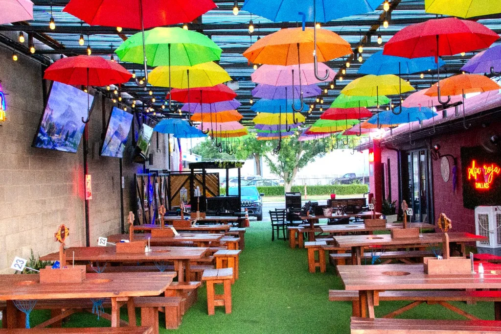 Salsa Roja Dallas patio under a canopy of colored umbrellas
